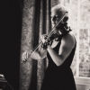 Black and white of Maura playing violin at an Anniversary party in Wilmington