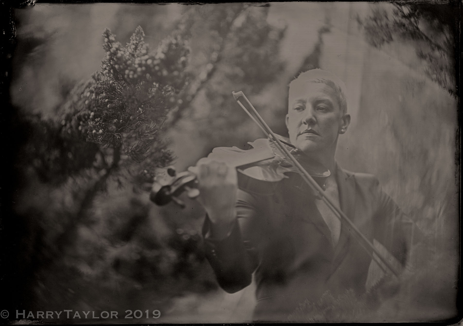Old-timey black and white photo of Maura with her violin