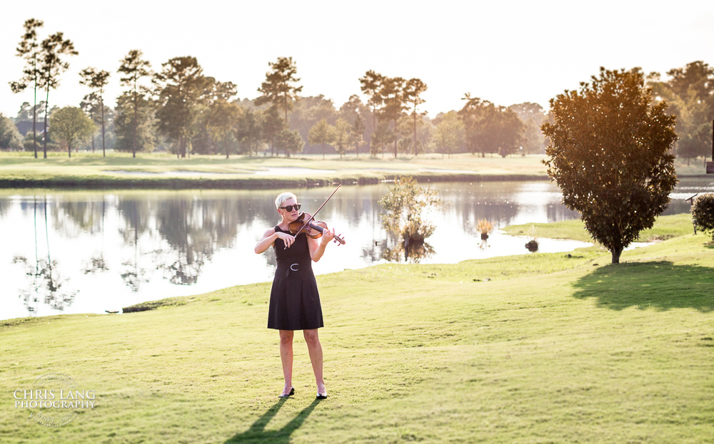 Maura playing violin on a Wilmington golf course