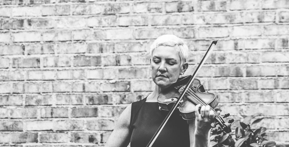 Black and white of Maura and her violin